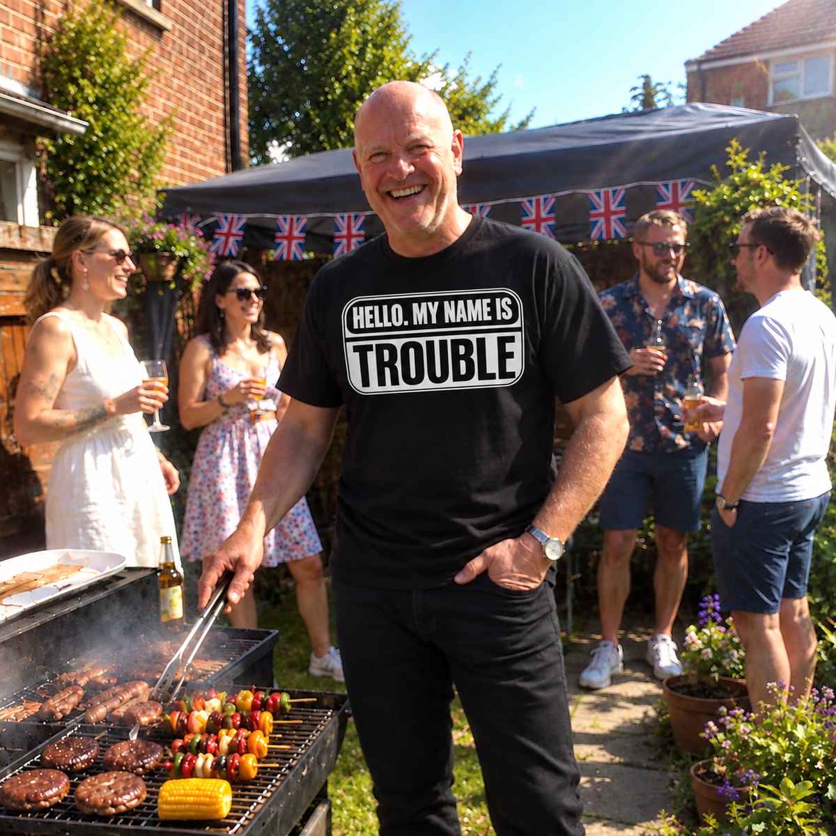 Man at garden barbecue wearing black Hello My Name Is Trouble T-shirt