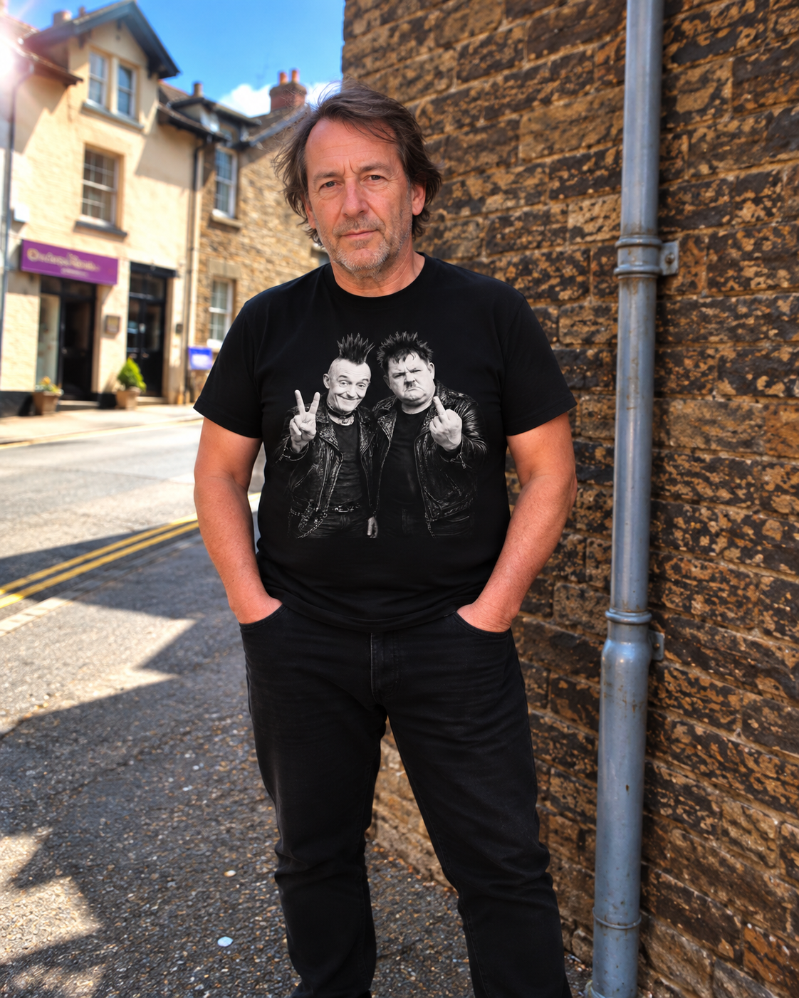 Man on a village street wearing black Laurel and Hardy Punk V2 graphic T-shirt
