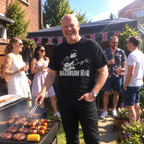 Man at a garden barbecue wearing the black Maximum R&B graphic T-shirt