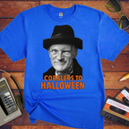 Blue t-shirt with a graphic of a man in a hat and text 'Cobblers to Halloween' on a wooden surface with vintage items.