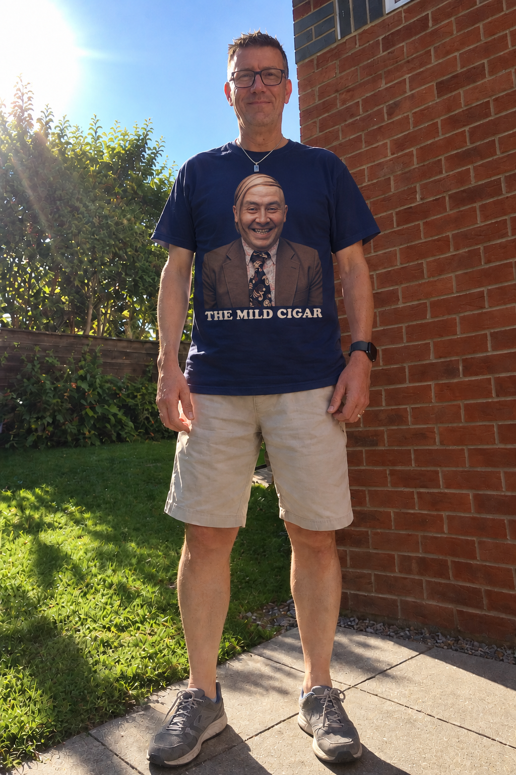 Man outdoors wearing navy The Mild Cigar graphic T-shirt